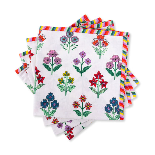 Set of four handmade Santini napkins featuring vibrant floral block prints and striped trim, perfect for festive dining.